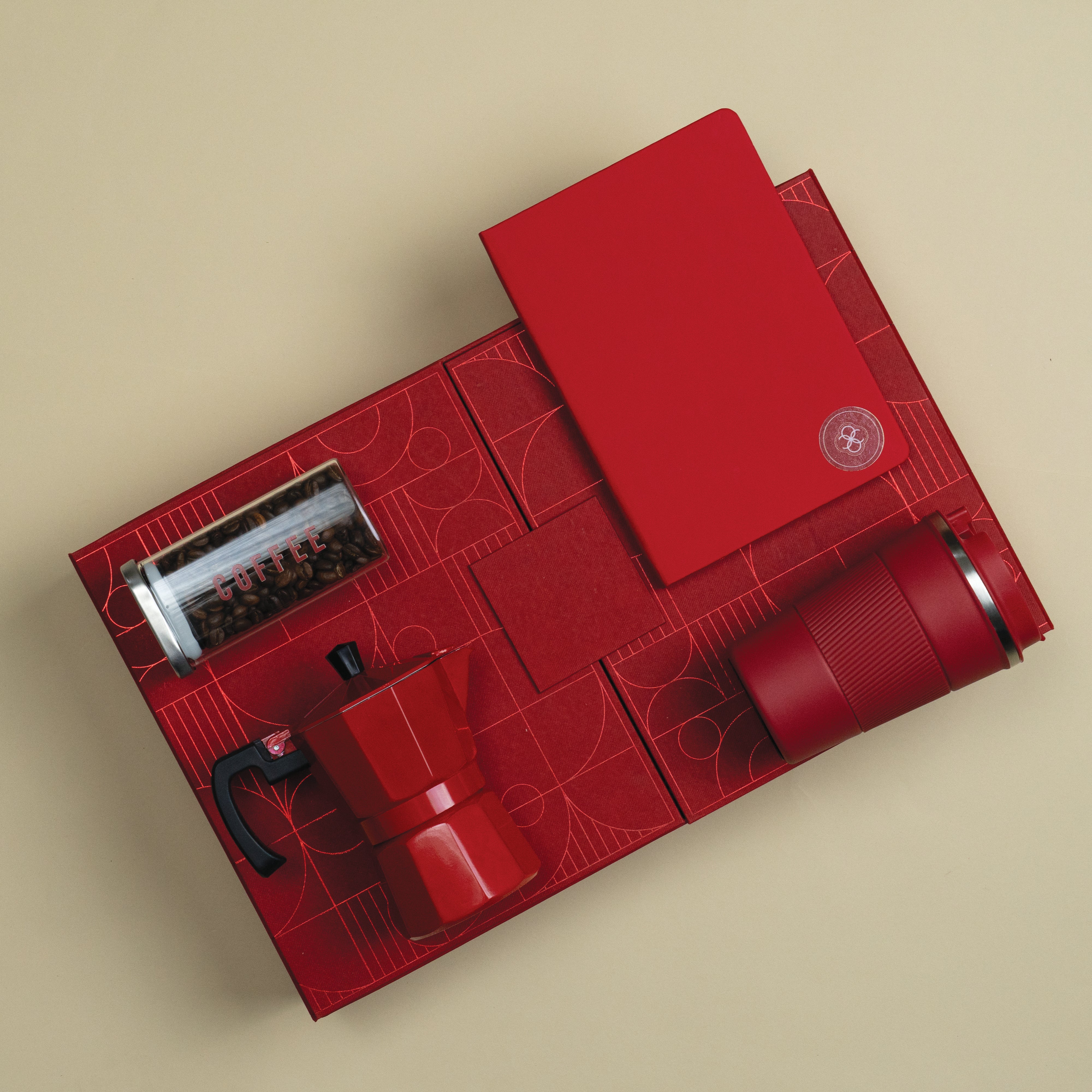 The Caffeine Hit red coffee-themed corporate gift set with an A5 notebook, stainless steel vacuum coffee mug, red moka pot and glass coffee jar.