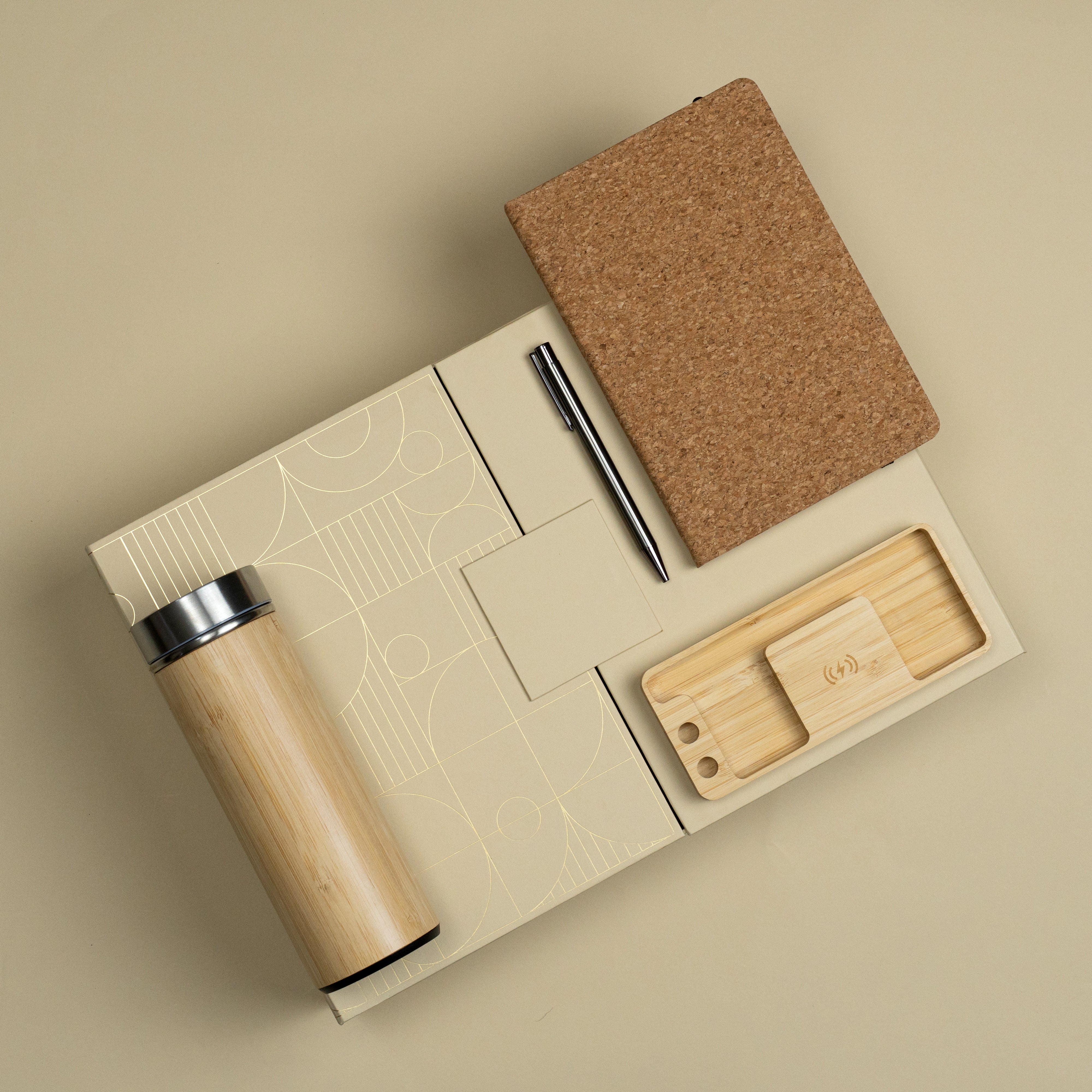 Logged In eco-inspired corporate gift set featuring a bamboo bottle, metallic pen, cork diary and multifunctional wireless charger.