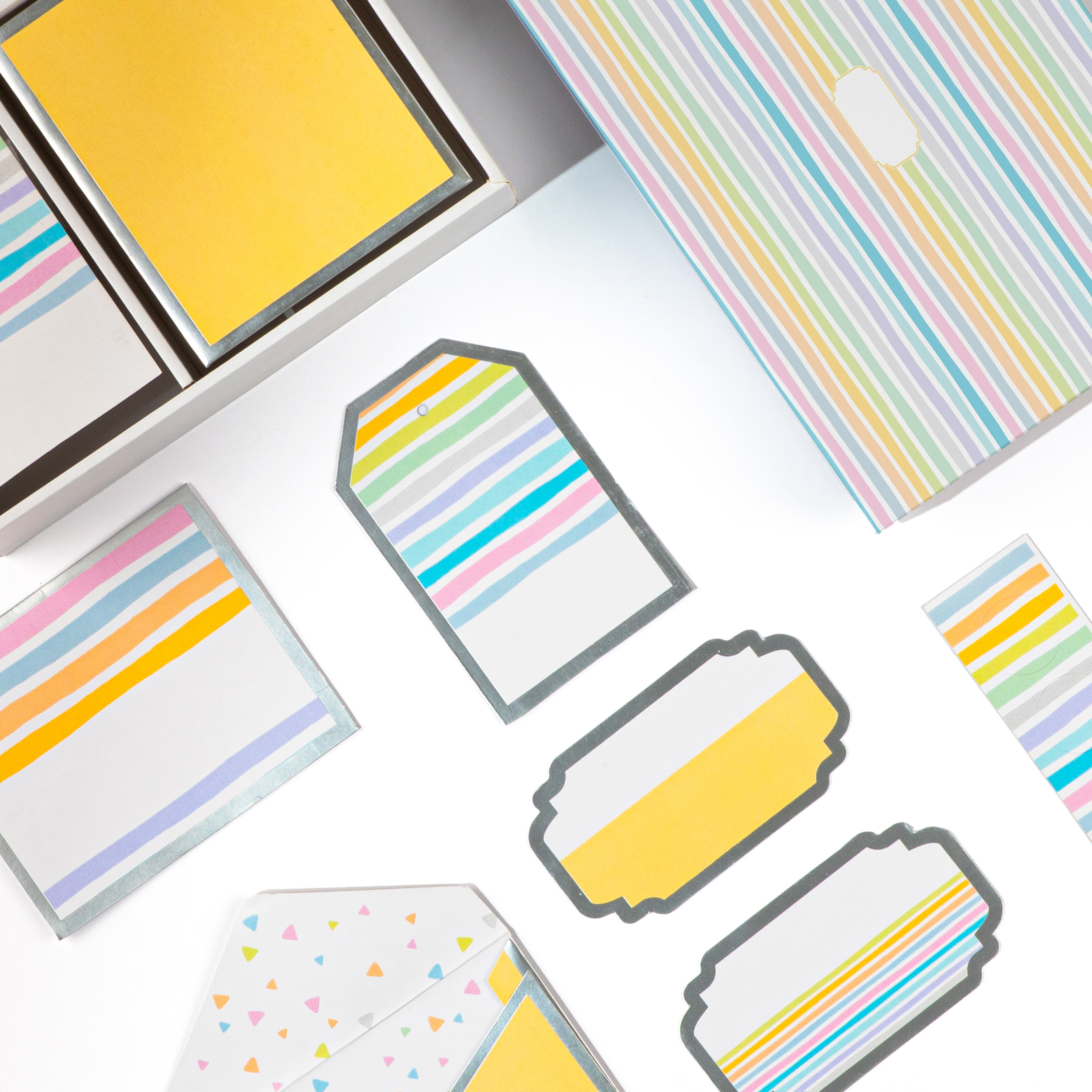 Colorful striped stationery set with gift tags and small folded envelopes.