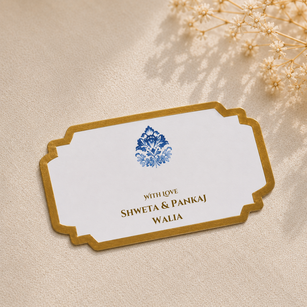Elegant white peel and stick gift tag featuring a royal blue floral motif with luxurious gold border detailing for premium gifting.