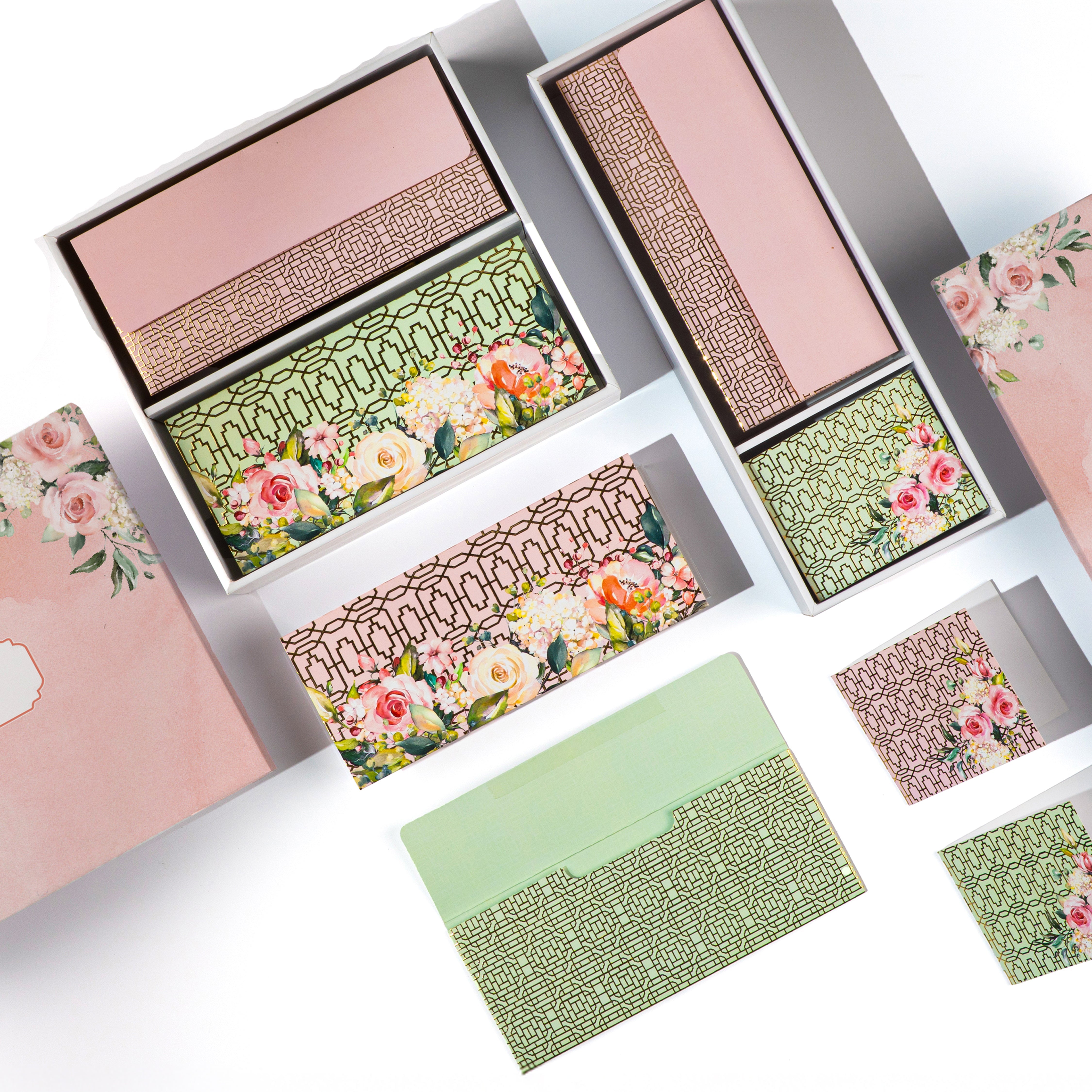 Pink floral stationery gift set with printed folded cards and envelopes.

