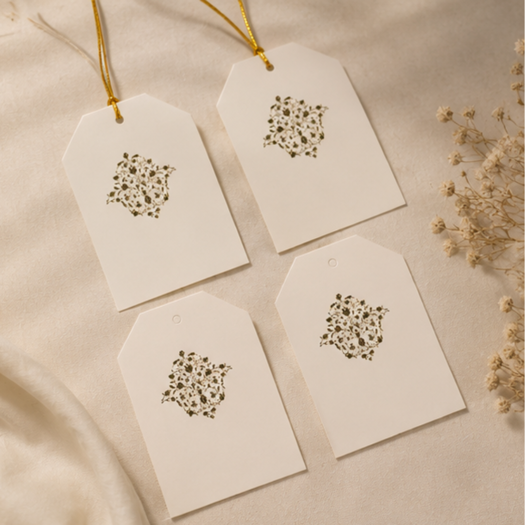 Sophisticated cream gift tag featuring subtle floral detailing and matching golden strings for luxury gifting and hamper styling.
