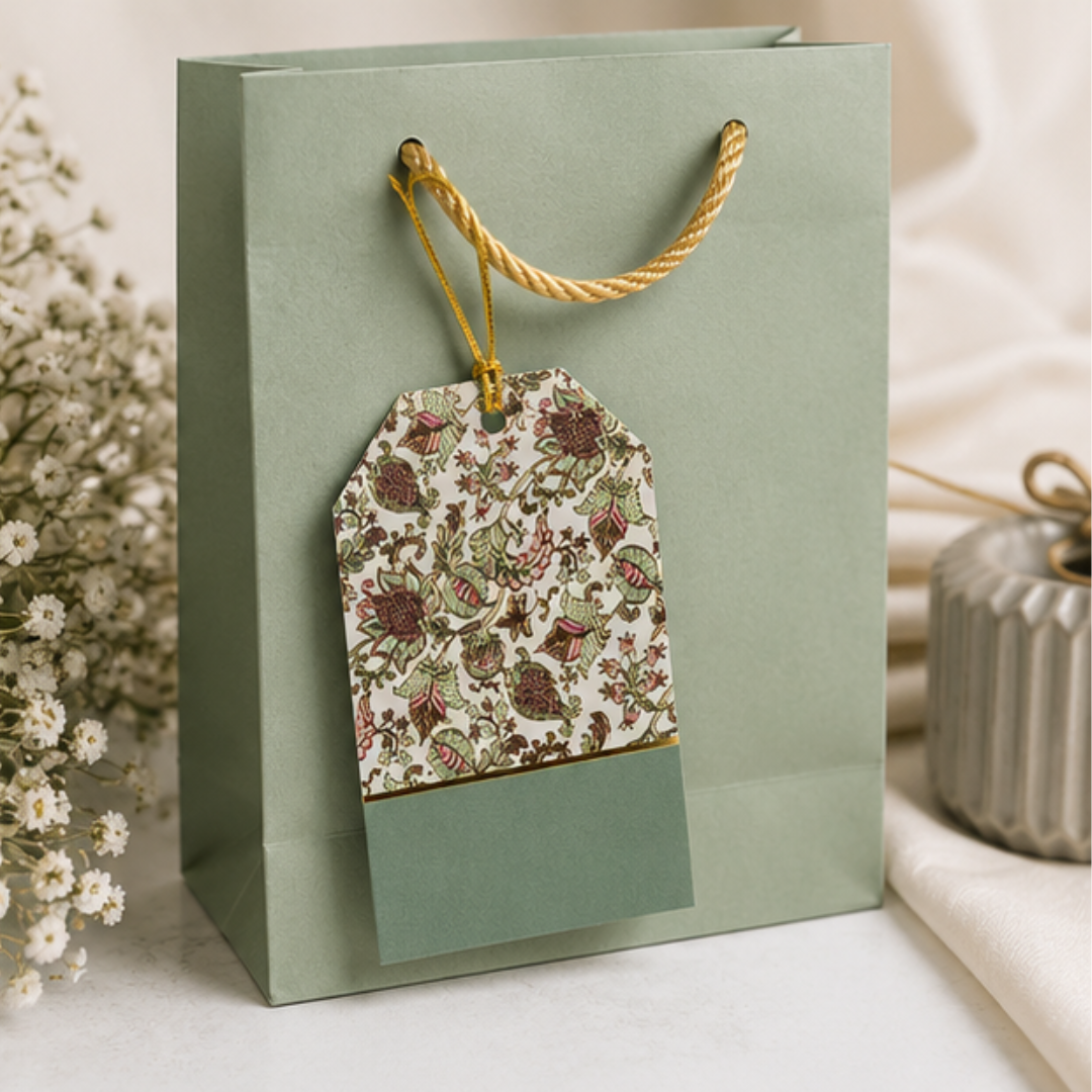 Premium botanical hanging gift tags with vintage floral motifs and sage accents, beautifully arranged in an elegant flat lay composition.