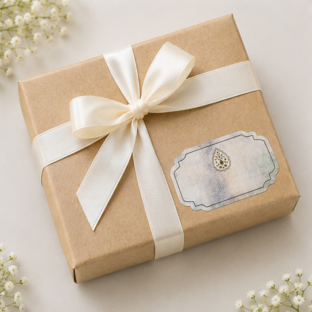Sophisticated pastel-toned sticker tag featuring subtle abstract artwork and intricate traditional emblem for luxury gifting.