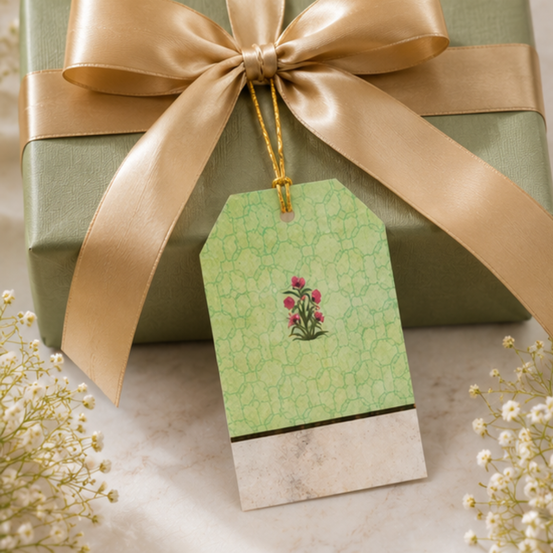 Premium sage green gift tag with intricate floral accents and golden dori, beautifully styled in an elegant flat lay arrangement.