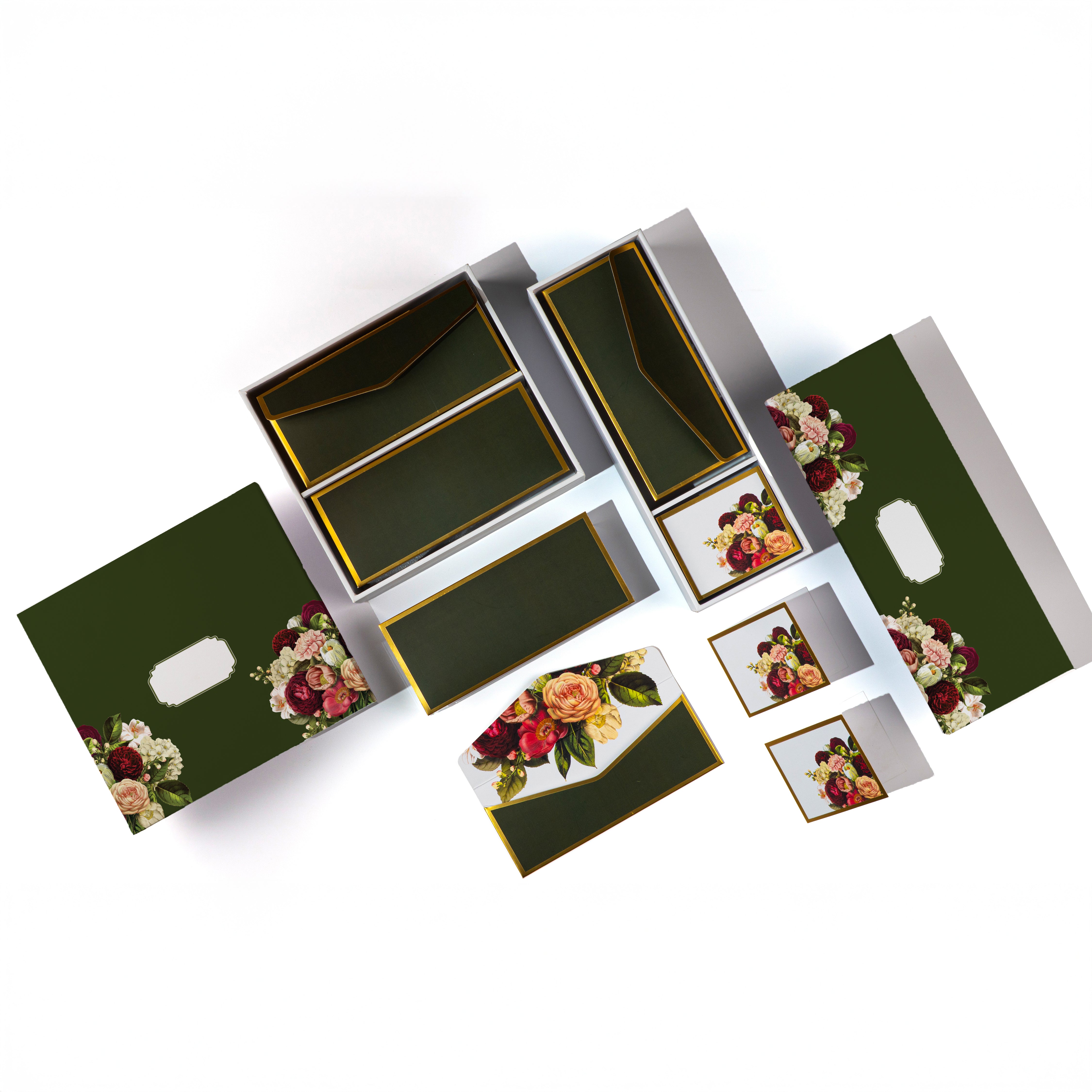 Dark green floral stationery set with gold accents, envelopes, and gift cards.

