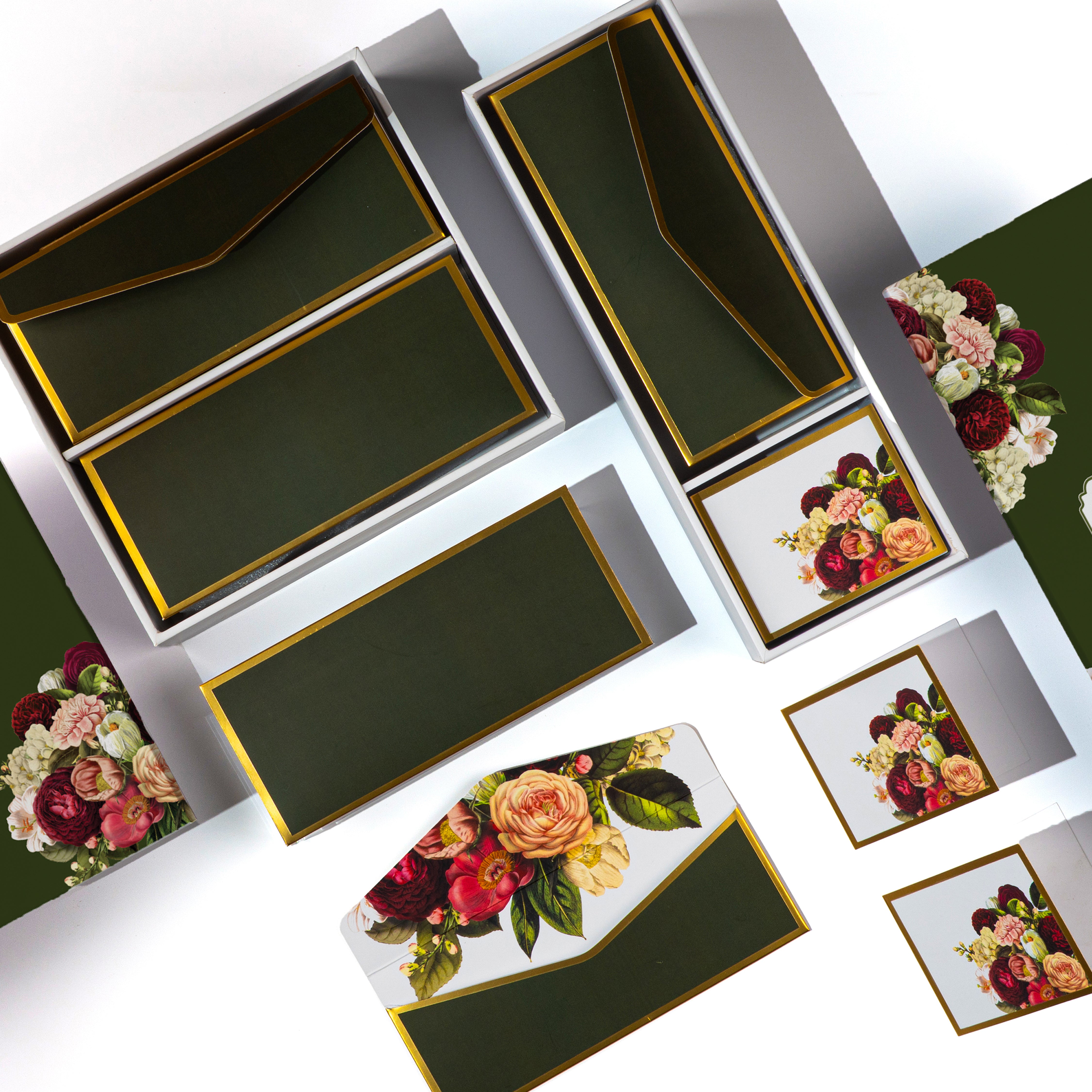 Dark green floral stationery set with gold accents, envelopes, and gift cards.


