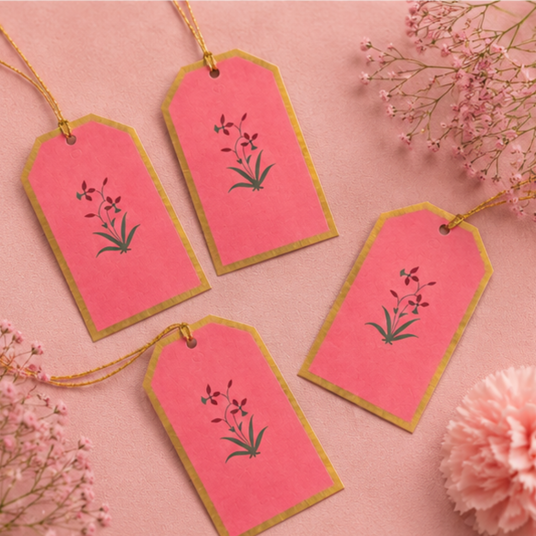Luxury pink gift tags with golden dori and minimal floral detailing, beautifully arranged in an elegant flat lay composition.