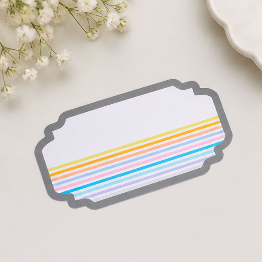 Minimal peel and stick gift tag with pastel rainbow stripes and elegant grey scalloped border for modern gifting.